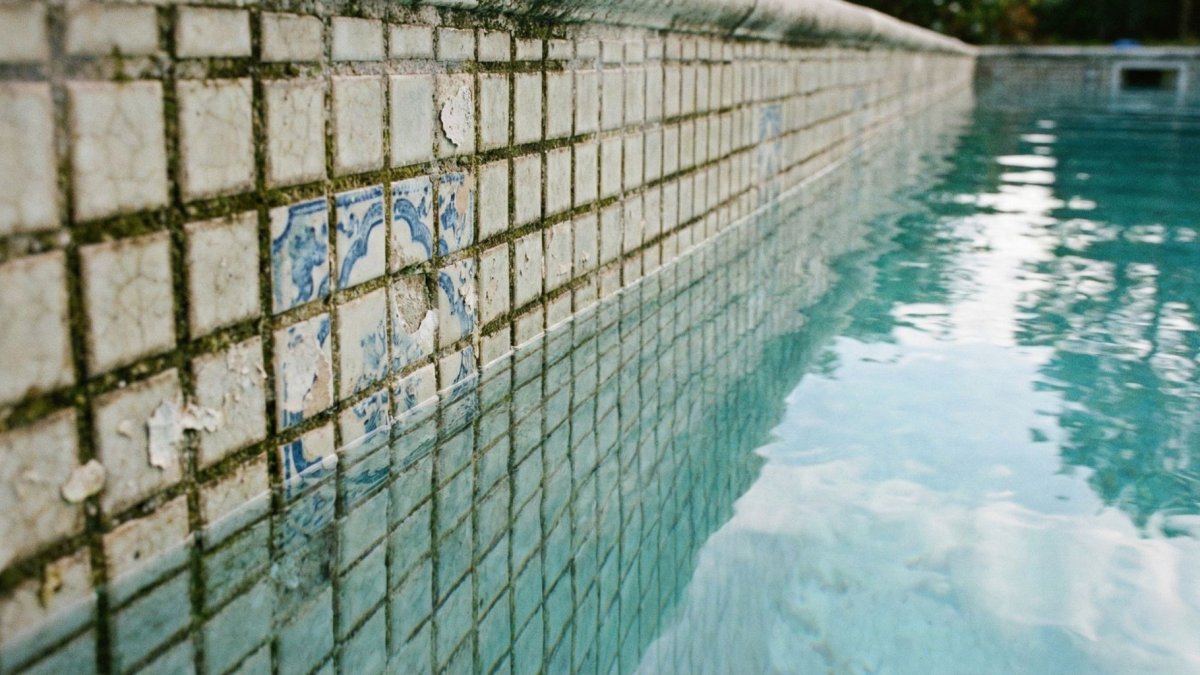 Piscine avec carrelage abîmé.